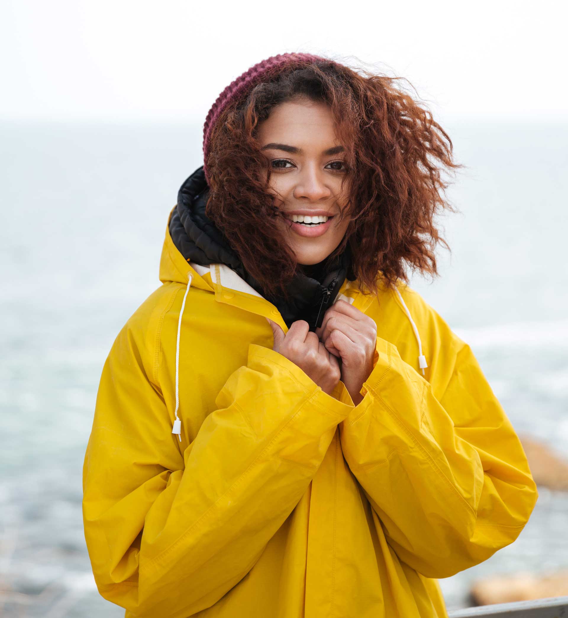 happy-african-curly-young-woman-wearing-yellow-PFCN4PV.jpg